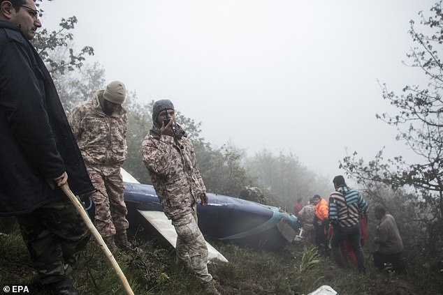 Iranian rescuers work near the wreckage of the crashed helicopter of the Iranian president, in the area of ​​Varzaghan, Tabriz province, southwestern Iran, May 20, 2024