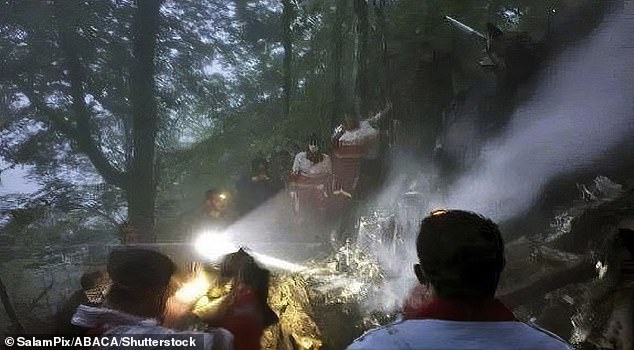 Rescuers are seen searching the crash site