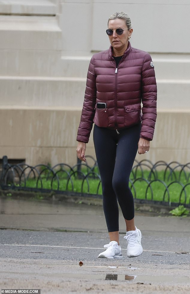 She dressed warmly against the cold weather in a maroon puffer jacket over a black shirt