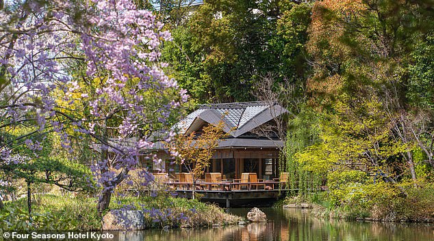 The cypress wood tea house overlooking the garden's tranquil pond