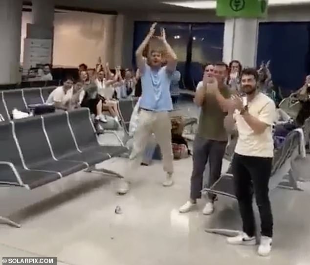 Fellow passengers applaud the success
