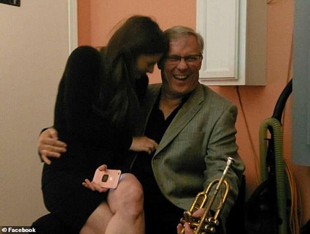 Vann, a retired teacher turned musician, holds a saxophone as Courtney sits on his lap.  The two met through their shared love of music when he helped her find musicians for an event