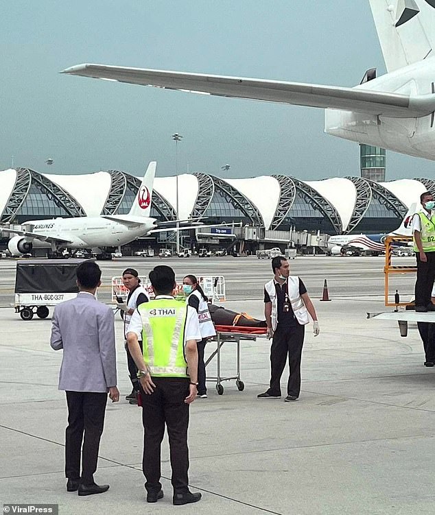 Today a person is carried off the plane on a stretcher in Bangkok