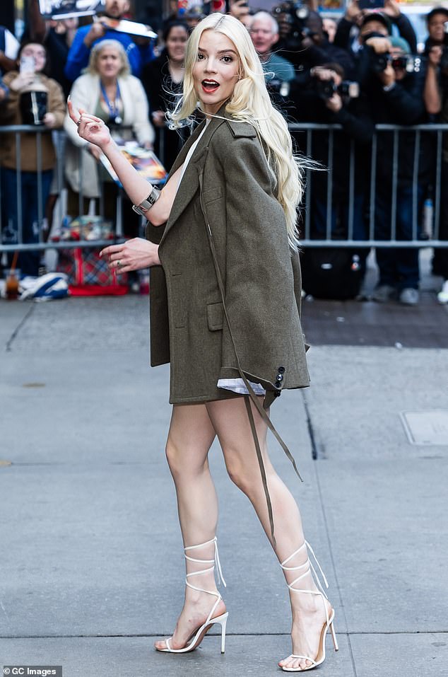 The blonde beauty appeared in good spirits as she was greeted by crowds of fans who showed up with flyers to support the acting sensation