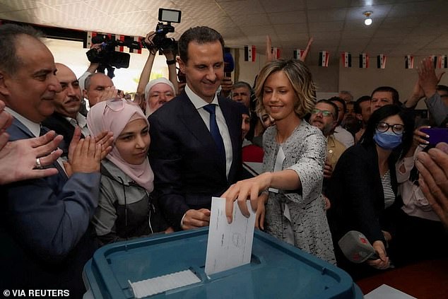 Asma al-Assad, wife of Syrian President Bashar al-Assad, casts her vote during the country's presidential elections in Douma, Syria, with her husband in this file photo taken in 2021
