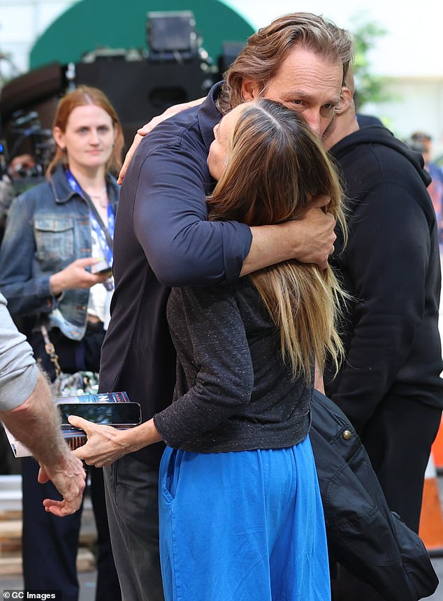 At one point, he gave a warm hug to Parker, who was holding her book, The Demon of Unrest: A Saga of Hubris, Heartbreak, and Heroism at the Dawn of the Civil War.