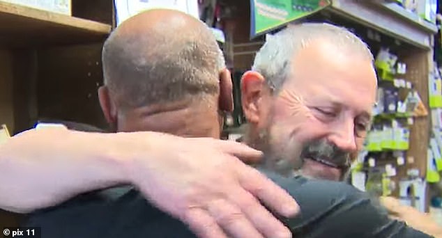 Vultee is seen hugging longtime client and friend, Brian White, on Friday as he became emotional over the news