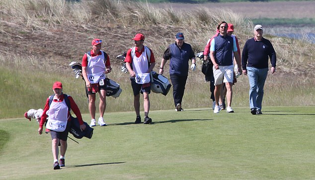 Prince Andrew pictured himself walking to his next shot on the golf course in Scotland this morning