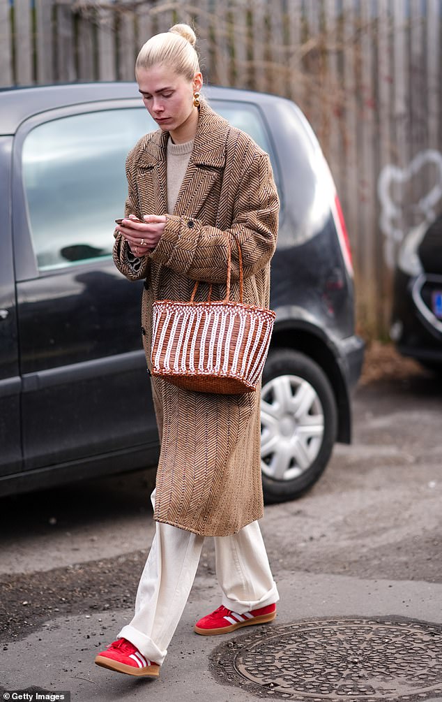 A guest at Copenhagen Fashion Week in January 2024 was seen wearing a bright red pair of Adidas Gazelles