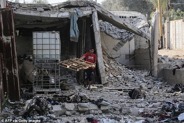 A Palestinian youth inspects the damage after the Israeli bombardment early May 22, 2024