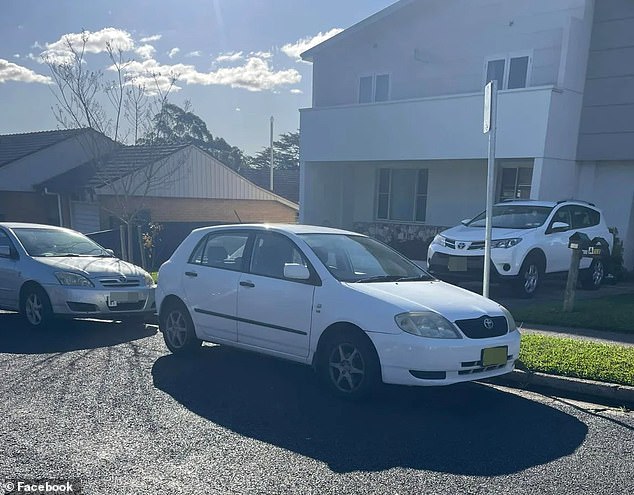 The white car, which was illegally parked on the street, was very close to another car, which was legally parked, resulting in a gap that was too small for the 4WD to exit the driveway (photo)