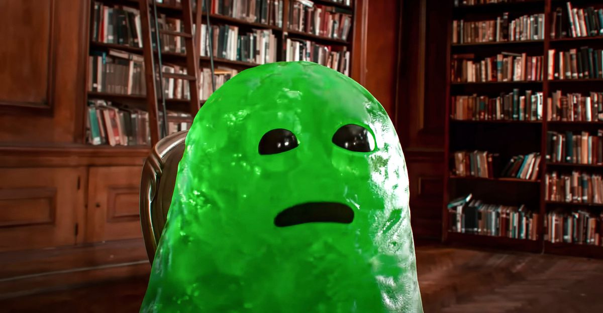 Slime, a CG imaginary friend who looks like a big green blob with shiny black eyes and a black gush for a mouth, sits in a library in John Krasinski's IF