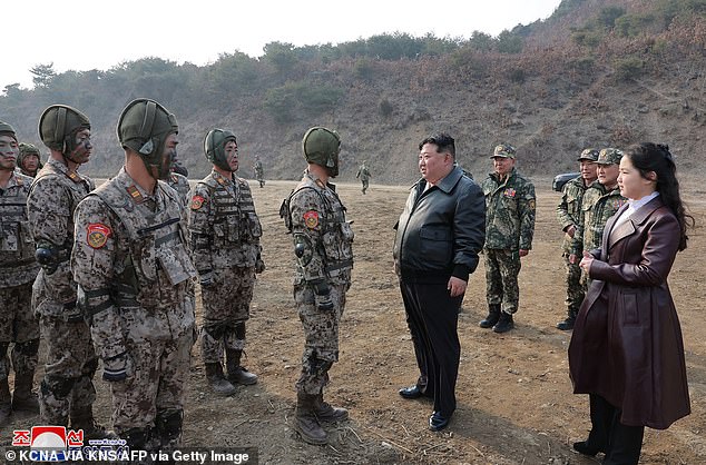 Kim Jong Un (front 2nd from right) and his daughter Ju Ae (R) inspect a Korean People's Army training session at a secret location in North Korea on March 15, 2024