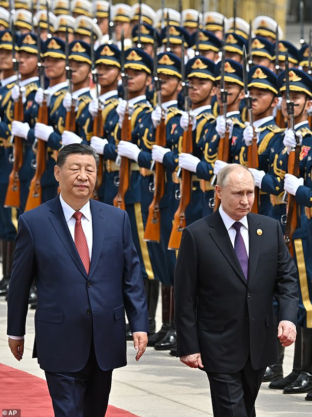 Chinese President Xi Jinping (left) and Russian President Vladimir Putin review the guard of honor during an official welcome ceremony in Beijing, China, Thursday, May 16, 2024