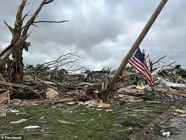 One image captured an American flag hanging diagonally from a wooden pole as piles of rubble lay around it