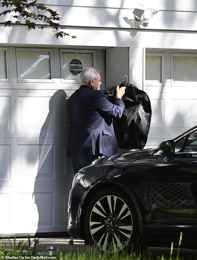 The Democrat also held up his bag to hide the code he entered to open his garage
