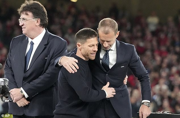 Alonso shared a hug with UEFA president Aleksander Ceferin on the trophy podium