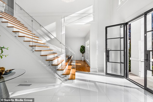 There's a two-story foyer, a grand staircase and glass railings, not to mention the high ceilings