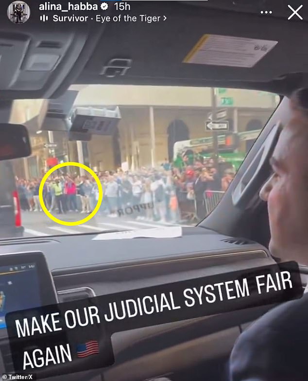 Another video from Trump's lawyer Alina Habba, shot from another car in the motorcade, also showed the exact same scene, with the same man and the same green crane