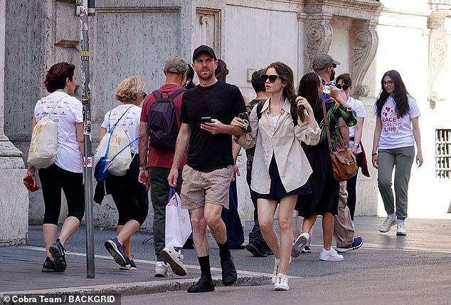 Meanwhile, her husband Charlie, 40, looked casual in a black T-shirt and checked shorts