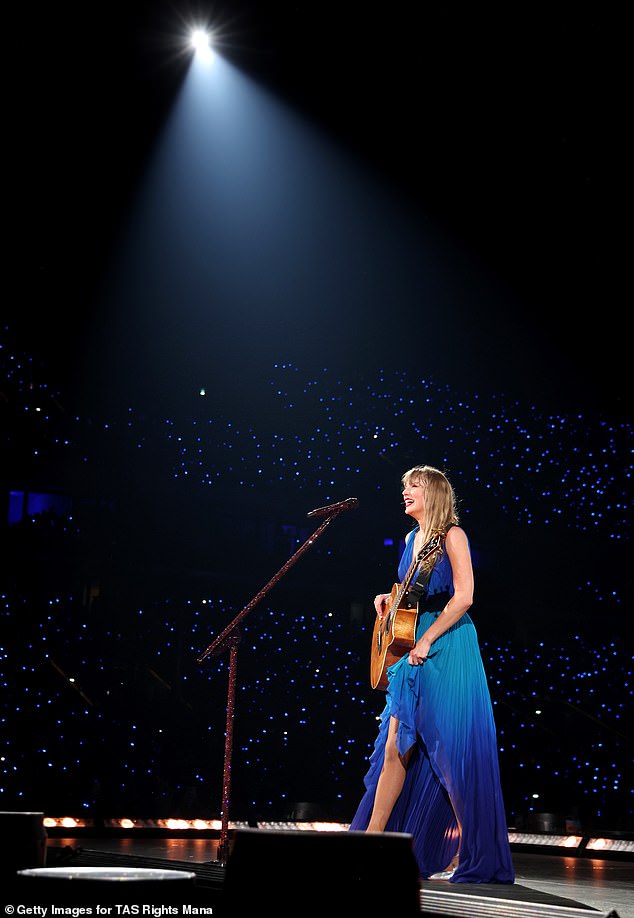 In a TikTok video, Swift was seen fiddling with the back of her royal blue wrap dress — where her microphone pack would be — while holding her guitar in one hand;  seen in the same dress in Paris on May 9