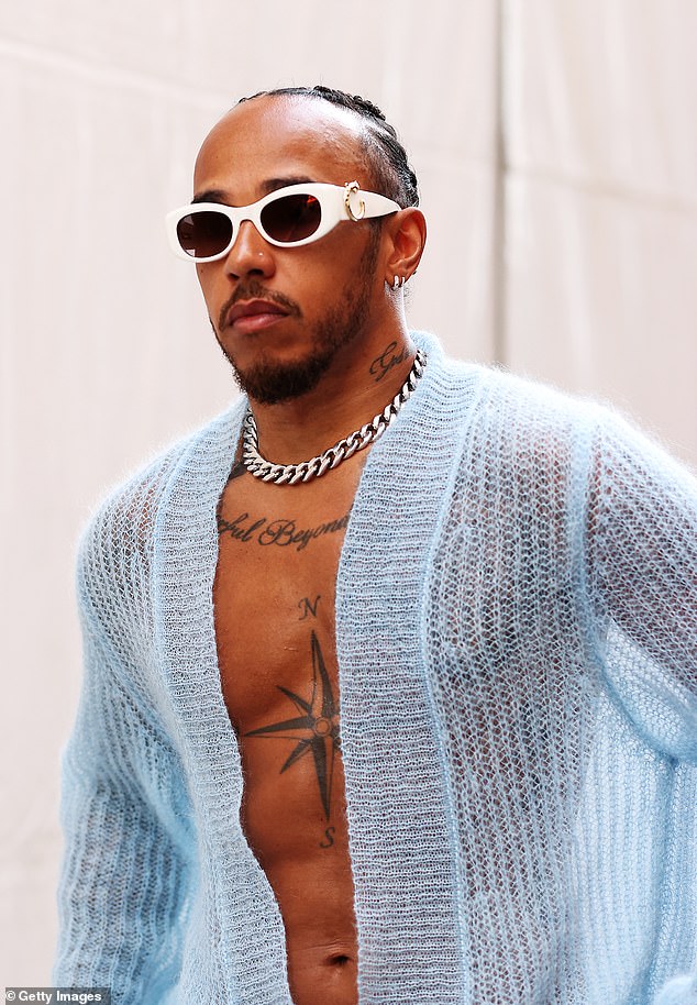 He paired his look with chunky royal blue sneakers, while accessorizing with statement white sunglasses and a silver chain