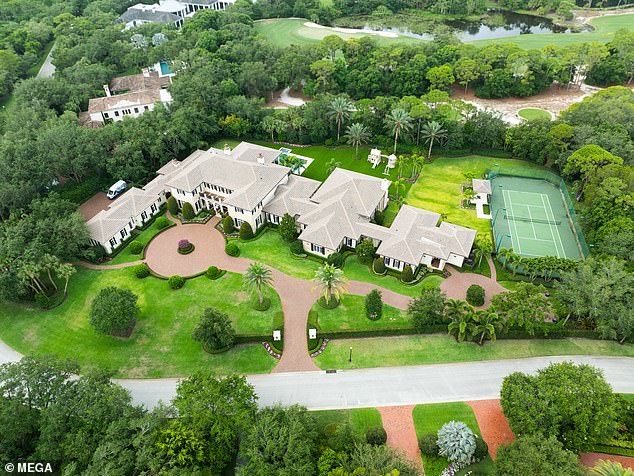 The aerial view of the house shows the entire driveway, as well as the family's tennis court and surrounding golf courses