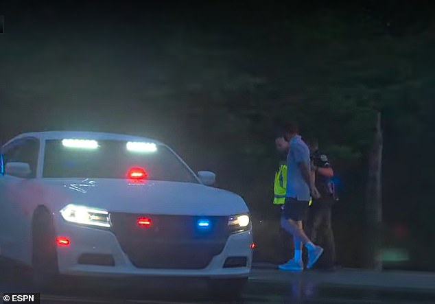 Remarkable footage showed the two-time Masters winner being led into a police car