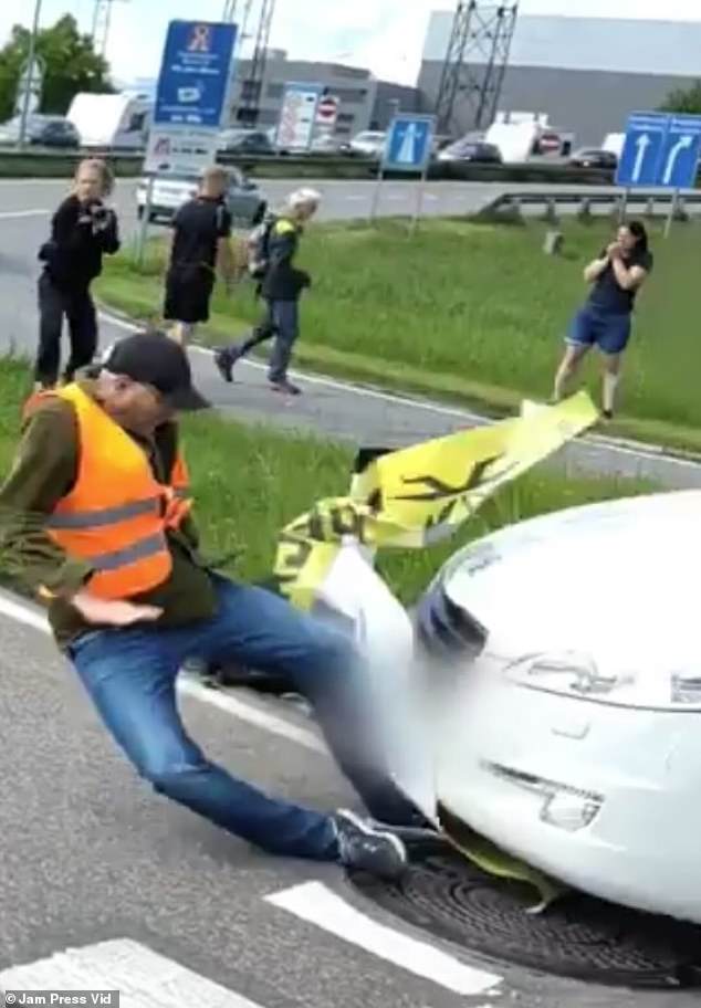 In a shocking video, a male eco-protester was knocked to the ground by a moving vehicle