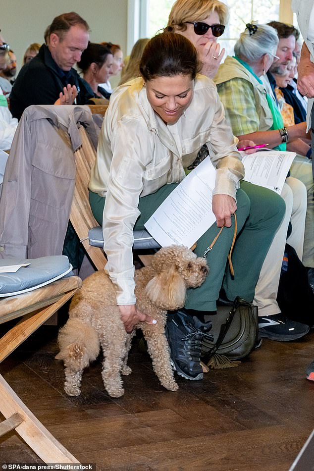She held the dog close to her as she sat in the meeting, which took place in the Swedish capital Stockholm