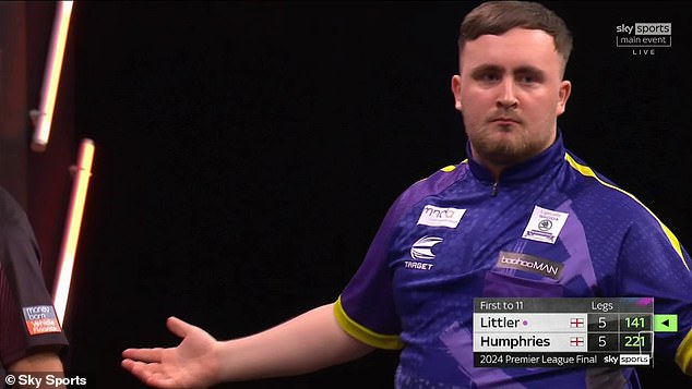 The 17-year-old enjoys the applause after hitting the nine-darter at the O2 Arena