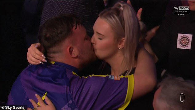 Littler kisses his girlfriend Eloise Milburn after winning his first ever Premier League Darts title