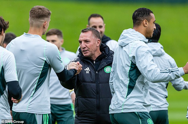 The Celtic boss looks relaxed as he chats to his players in training