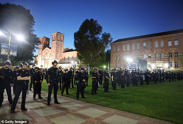 LAPD officers stand guard near a pro-Palestinian encampment after a dispersal order was issued on the UCLA campus on May 1, 2024