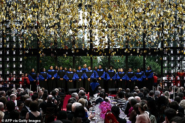The Howard University Gospel Choir performs in a glass pavilion on the South Lawn where the state dinner took place