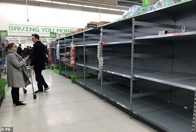 Empty shelves where toilet rolls are usually stored in an Asda store in Clapham Junction, London, March 7, 2020