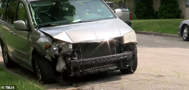 A gray sedan crashed into a parked minivan, causing significant damage as debris flew everywhere