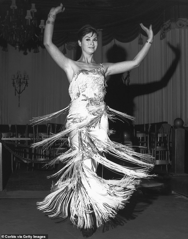 Tall, thin and beautiful, April became a supermodel.  Pictured here during a song and dance act at the Astor Club in London's West End in 1962