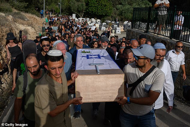 Atim Louk (L) is one of the pallbearers carrying his sister Shani Louk's coffin on May 19, 2024 in Srigim-Li On, Israel
