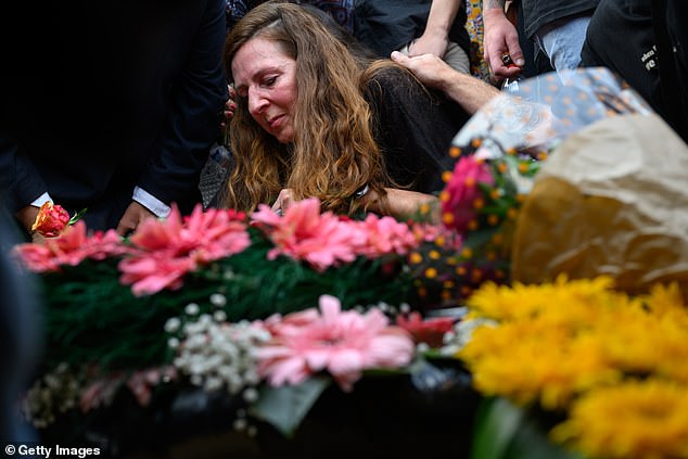 Ricarda Louk places a flower on the grave of her daughter Shani Louk on May 19, 2024 in Srigim-Li On, Israel