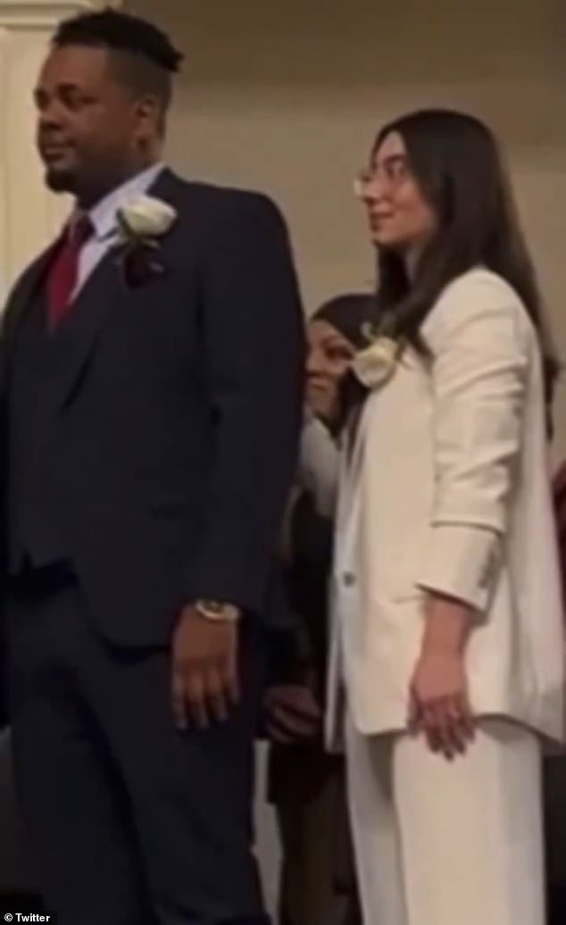 Tania Fernandes Anderson (pictured in background center) did not appear to repeat the oath in a video that has since gone viral on social media after the City Hall ceremony