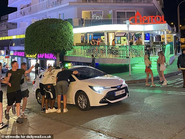British holidaymakers could face holiday chaos this summer as Mallorcans step up their anti-tourism campaign by threatening to block the island's airport and protesting outside hotels (pictured: holidaymakers partying in Mallorca)