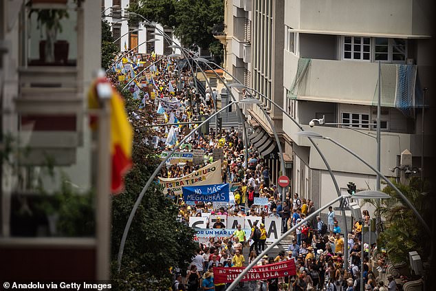 Protesters flooded the streets of Tenerife last month (pictured) calling on local authorities to temporarily limit visitor numbers to ease pressure on the island's environment, infrastructure and housing stock, and to ban property purchases by foreigners restrict