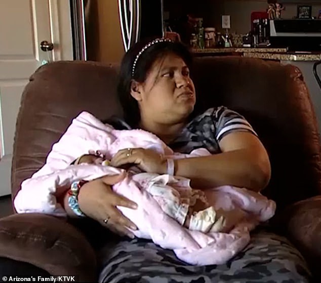 Vedarte-Gonzalez is pictured holding her newborn daughter Luzbella