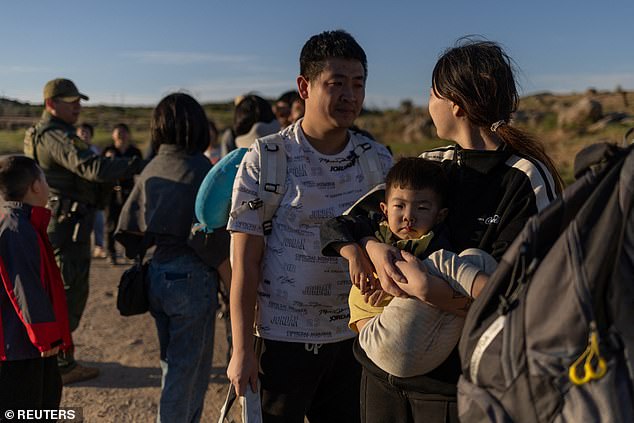 An asylum-seeking family from Henan Province, China, surrenders to officials after crossing the border into the United States from Mexico in Jacumba Hot Springs, California, U.S., May 13, 2024