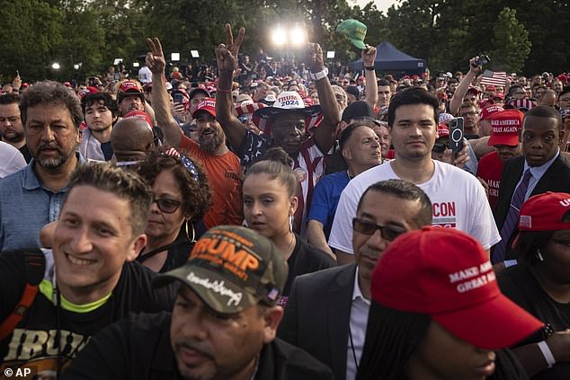 Crowds of Trump supporters listen to Trupm's speech in Crotona Park as the sun sets