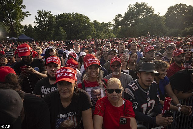 Trump supporters in MAGA hats look toward the stage as the ex-president holds a rally