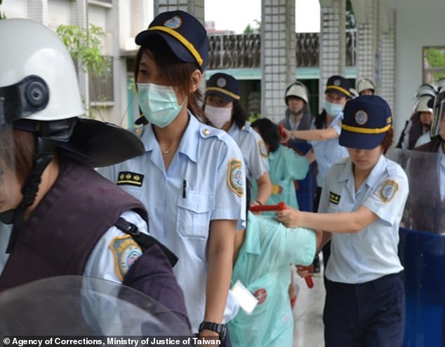 Prisoners are accompanied by guards in the prison, where mainly drug prisoners are held (file image)