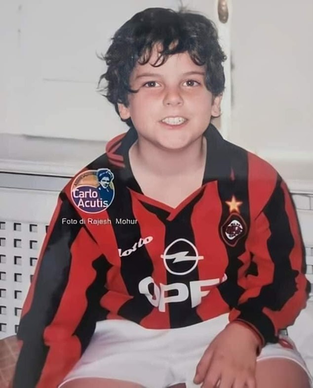 Carlo Acutis was photographed smiling at the camera while wearing an AC Milan home kit from the 1990s