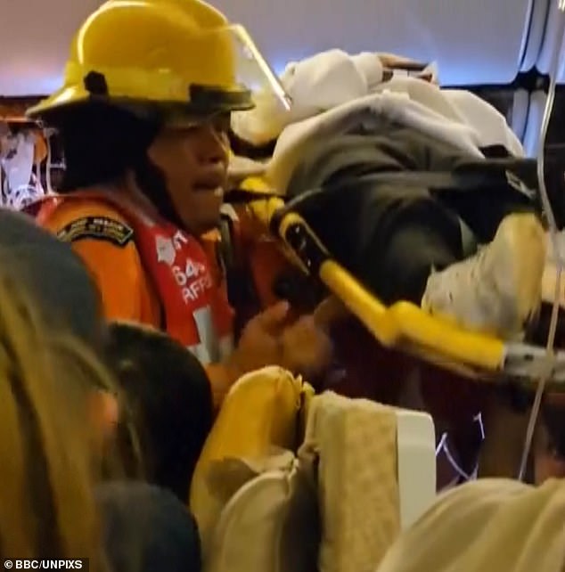 Thai rescue workers hurriedly transport seriously injured passengers on stretchers